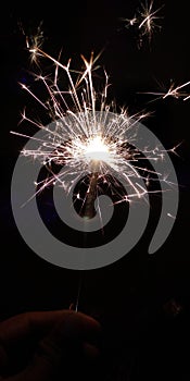 AÂ sparklerÂ is a small firework that you can hold as it burns. It looks like a piece of thick wire and burns with a lot of us.